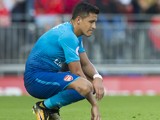 Alexis Sanchez sits dejected during the Premier League game between Liverpool and Arsenal on August 27, 2017