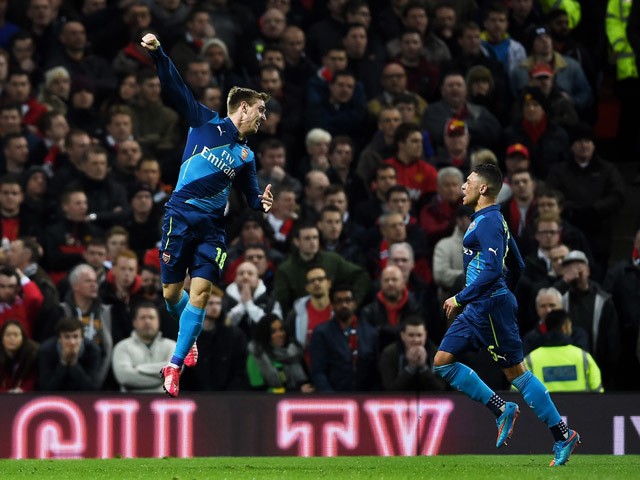 Nacho Monreal of Arsenal celebrates after scoring the opening goal with teammate Alex Oxlade-Chamberlain of Arsenal during the FA Cup Quarter Final match between Manchester United and Arsenal at Old Trafford on March 9, 2015